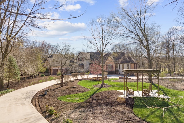 view of property's community featuring a patio area and a lawn