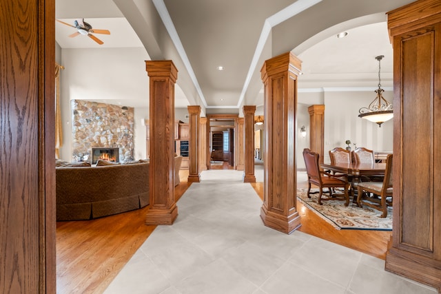 hallway with light hardwood / wood-style floors and decorative columns