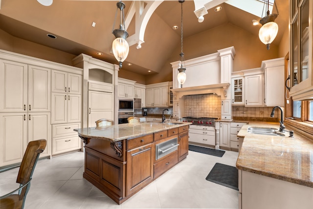 kitchen featuring an island with sink, pendant lighting, and stainless steel appliances