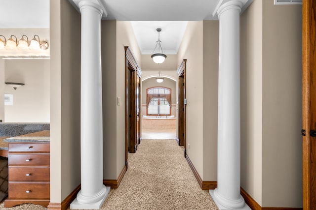 hall with light colored carpet