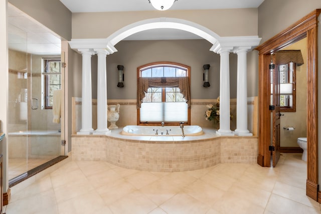 bathroom featuring toilet, independent shower and bath, and tile patterned flooring