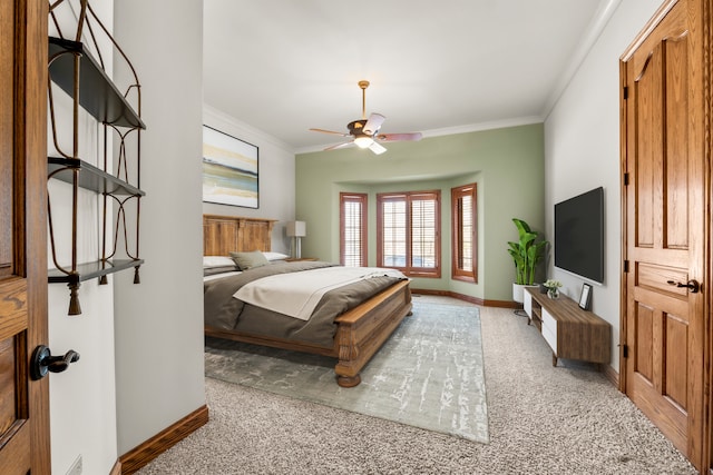 bedroom with ceiling fan, ornamental molding, and light colored carpet