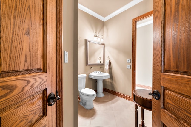 bathroom featuring ornamental molding, sink, toilet, and tile patterned flooring