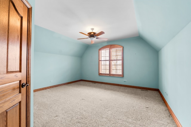 additional living space featuring ceiling fan, carpet, and vaulted ceiling