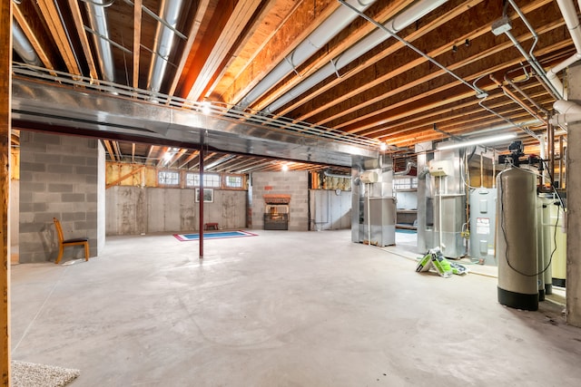 basement featuring heating unit and water heater