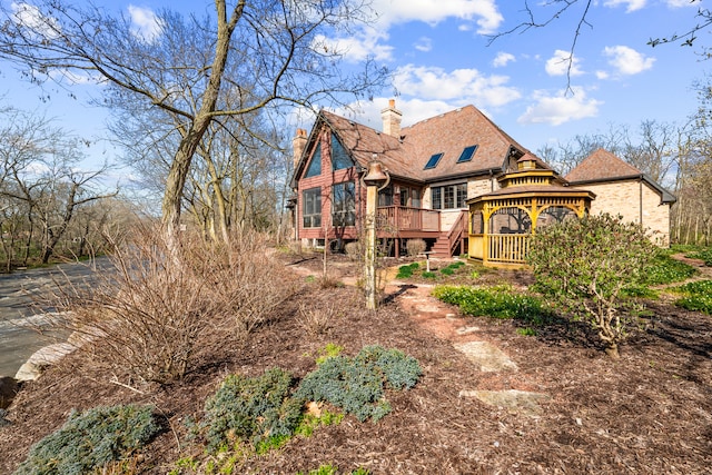 back of property featuring a gazebo and a wooden deck