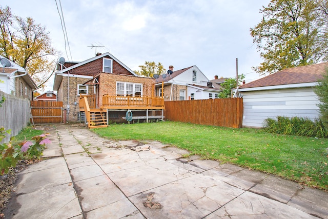 back of property featuring a patio area, a yard, and a deck