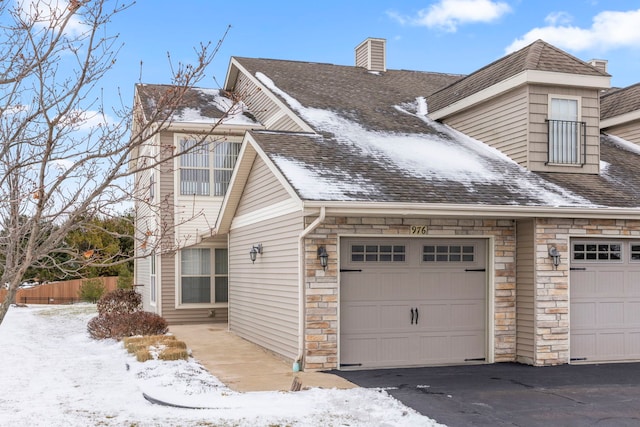 view of snow covered exterior featuring a garage