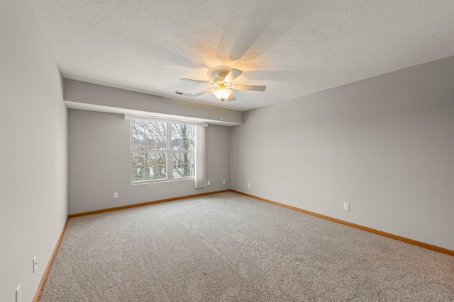 spare room with carpet flooring, a textured ceiling, and ceiling fan