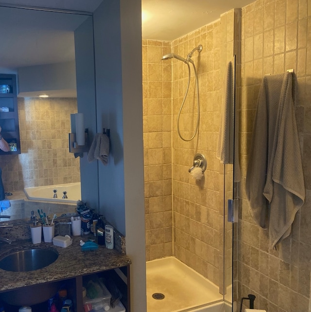 bathroom with a shower with door and sink