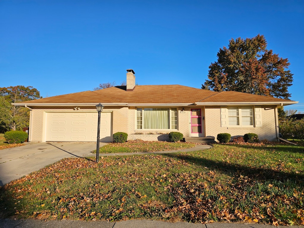 single story home with a front lawn and a garage