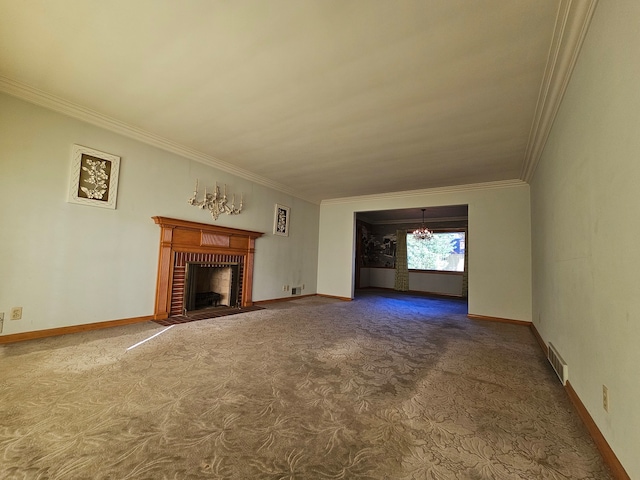 unfurnished living room featuring crown molding, a notable chandelier, carpet flooring, and a brick fireplace