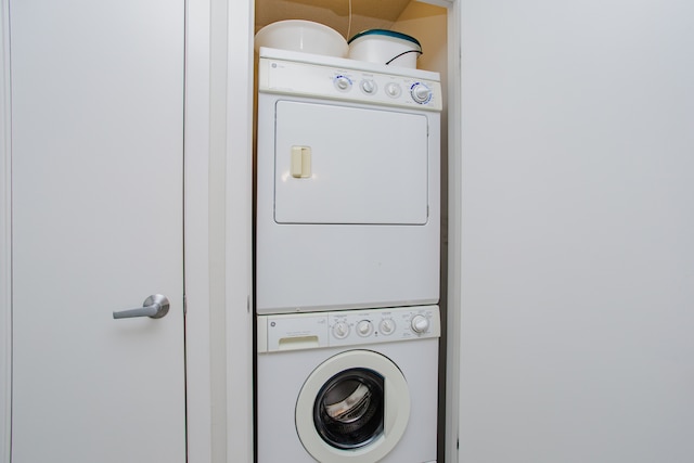 clothes washing area featuring stacked washer / drying machine