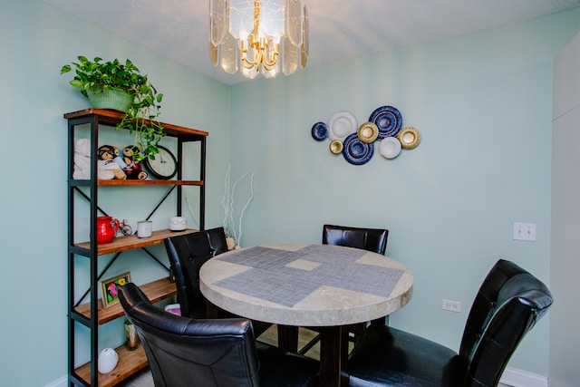 dining space featuring a textured ceiling and a notable chandelier