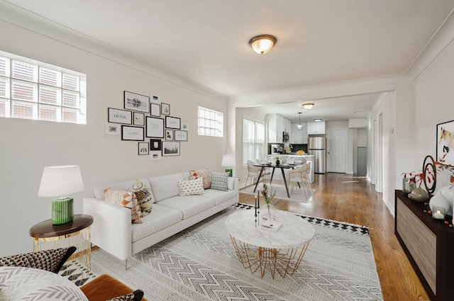 living room featuring crown molding and light wood-type flooring