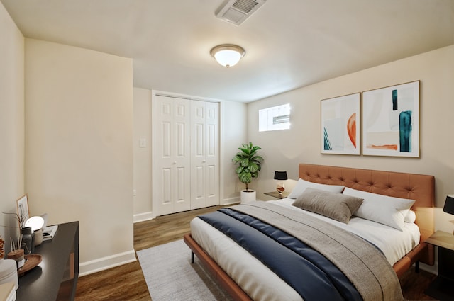 bedroom with a closet and dark hardwood / wood-style flooring