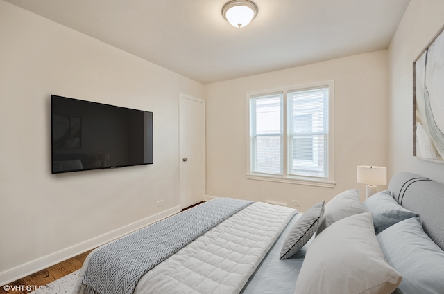 bedroom with hardwood / wood-style floors