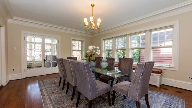 dining area with ornamental molding, dark hardwood / wood-style flooring, and a chandelier