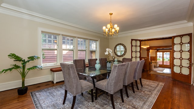 dining space featuring an inviting chandelier, crown molding, and dark wood-type flooring