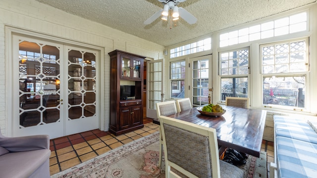 tiled dining area with french doors, ceiling fan, and a textured ceiling