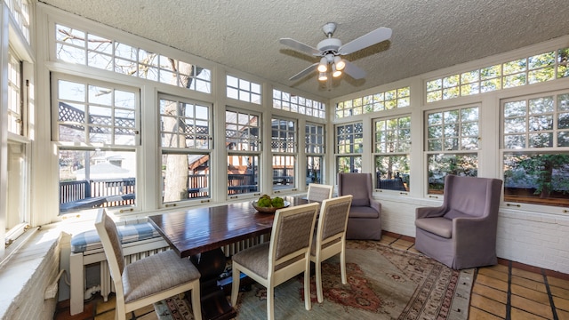 sunroom featuring ceiling fan