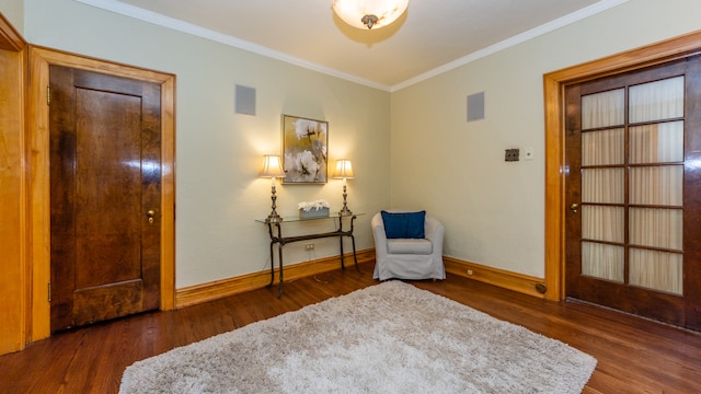 living area featuring crown molding and dark hardwood / wood-style floors