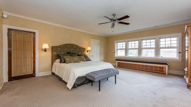 carpeted bedroom with radiator, ornamental molding, and ceiling fan