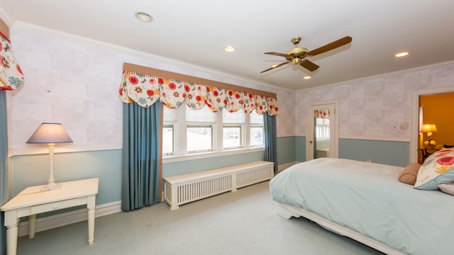 carpeted bedroom featuring crown molding, radiator heating unit, and ceiling fan