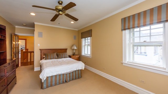 carpeted bedroom featuring ceiling fan and ornamental molding