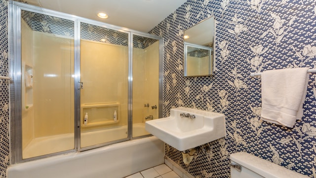 full bathroom featuring sink, tile patterned floors, enclosed tub / shower combo, and toilet