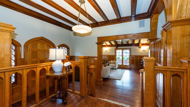 interior space with beamed ceiling, dark hardwood / wood-style floors, decorative columns, and french doors