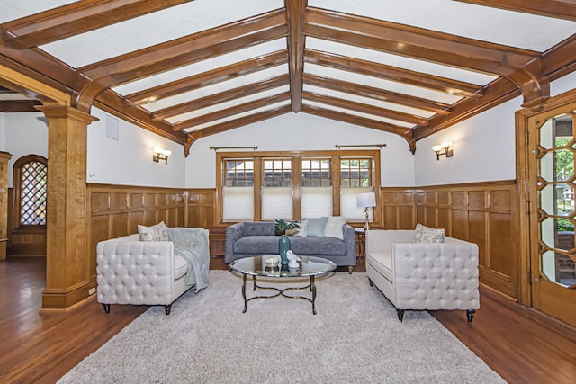 living room with dark hardwood / wood-style flooring, vaulted ceiling with beams, and ornate columns