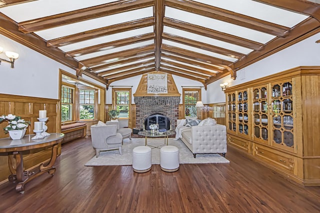 living room with a fireplace, dark hardwood / wood-style floors, and vaulted ceiling with beams