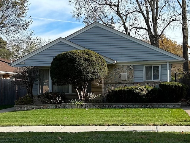 bungalow-style home with a front yard