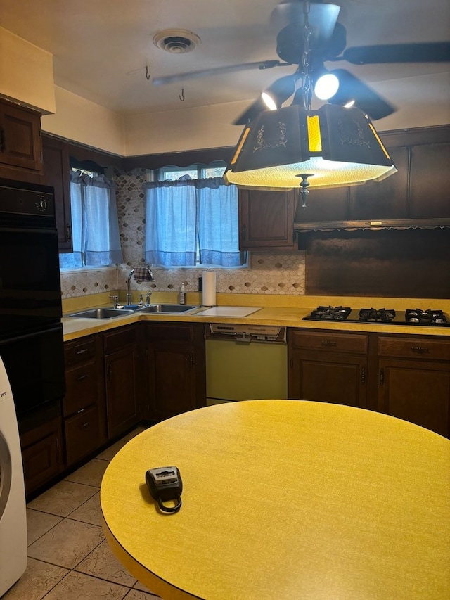 kitchen featuring black appliances, sink, ceiling fan, dark brown cabinets, and washer / clothes dryer