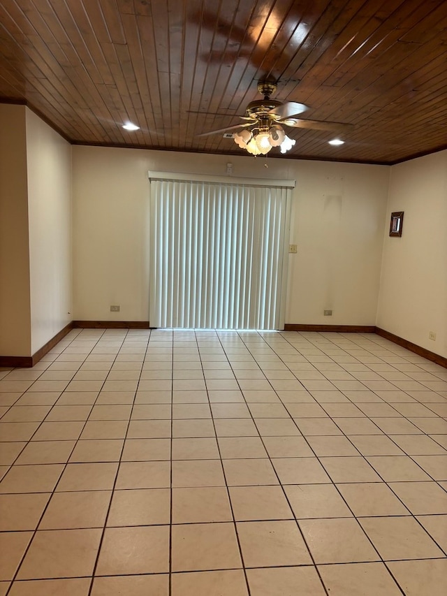 tiled empty room with ceiling fan and wooden ceiling