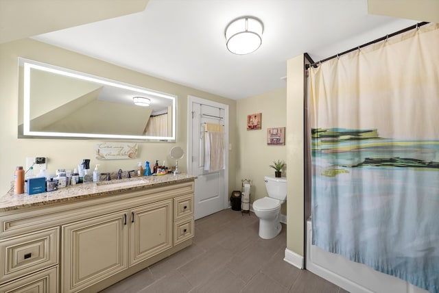 bathroom featuring toilet, walk in shower, and vanity