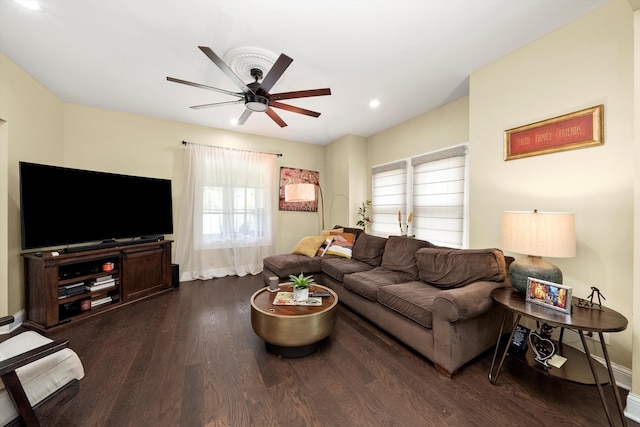 living room with a wealth of natural light, ceiling fan, and dark hardwood / wood-style flooring