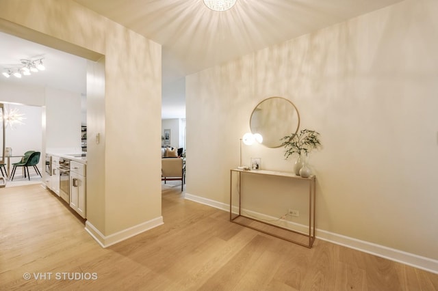 1325 N State Pkwy Unit 11F, Chicago, IL 60610 - hall with light wood-style floors, baseboards, and a chandelier