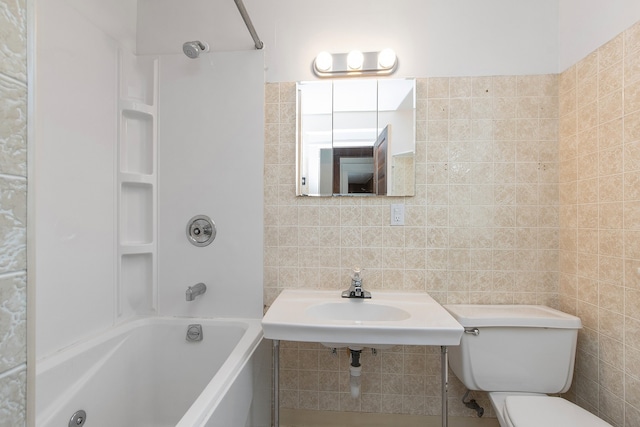 full bathroom featuring tile walls, toilet, and shower / bath combination