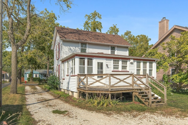 back of property featuring a wooden deck