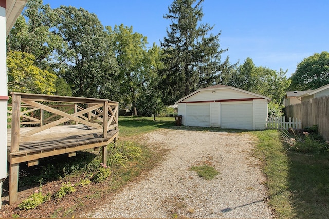 exterior space featuring a garage and an outbuilding