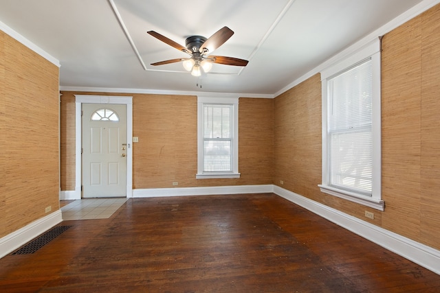 foyer entrance featuring ornamental molding, dark hardwood / wood-style floors, and ceiling fan