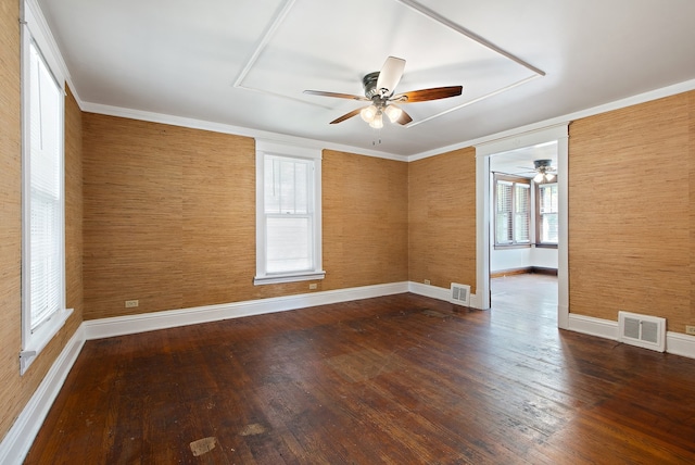 unfurnished room with hardwood / wood-style flooring, plenty of natural light, and wood walls