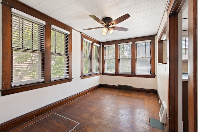 unfurnished sunroom with ceiling fan and plenty of natural light