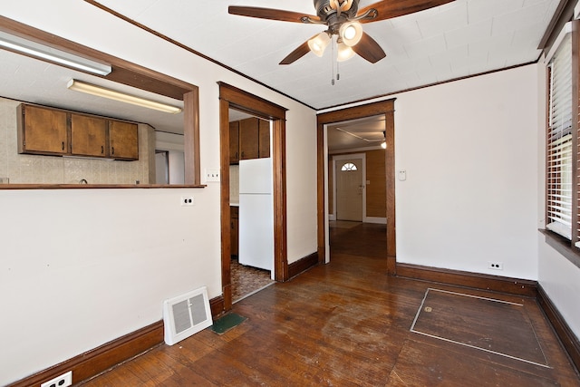 spare room featuring ceiling fan, ornamental molding, and dark hardwood / wood-style floors