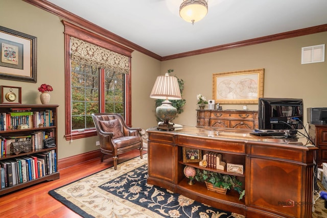 home office featuring crown molding and light hardwood / wood-style flooring