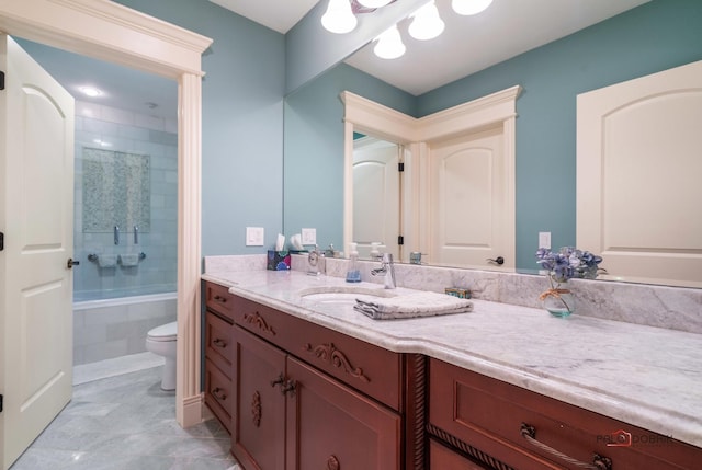 full bathroom with tile patterned floors, vanity, toilet, and tiled shower / bath