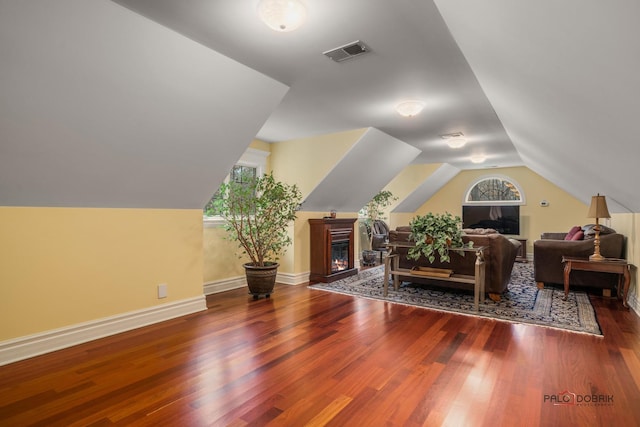 bonus room with vaulted ceiling and dark hardwood / wood-style floors