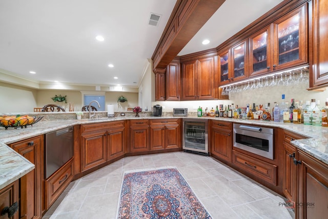 kitchen with crown molding, light stone counters, sink, and beverage cooler